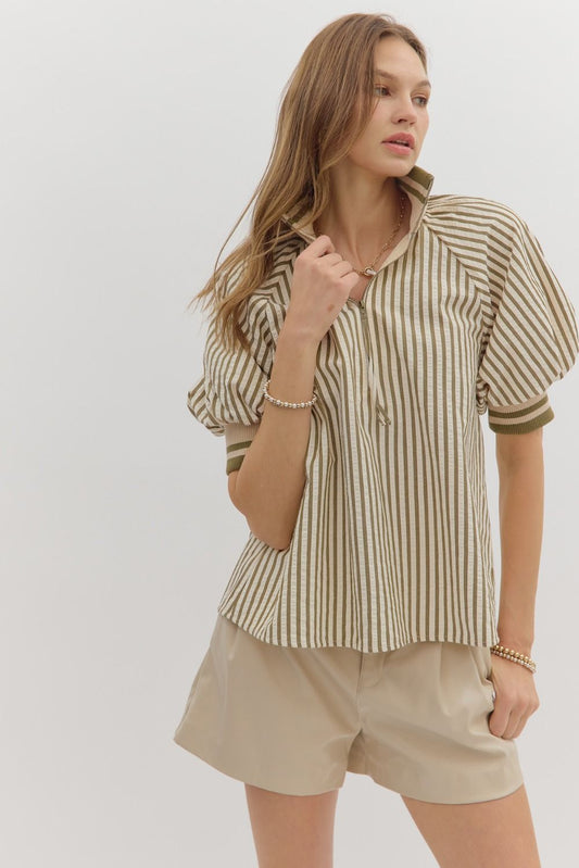 Woman wearing a striped shirt and shorts on a white background
